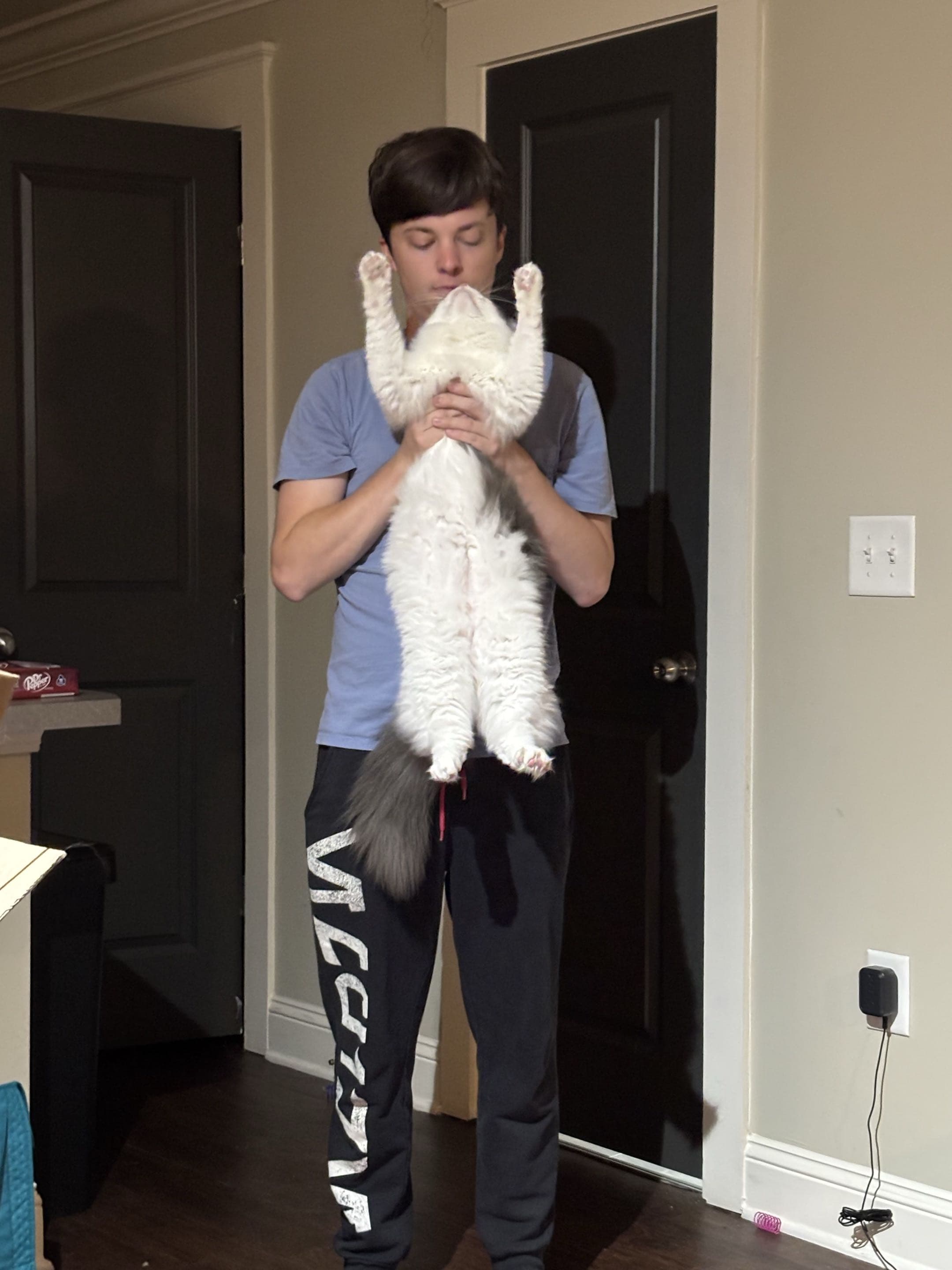 Max holding our white, fluffy cat named Bucky